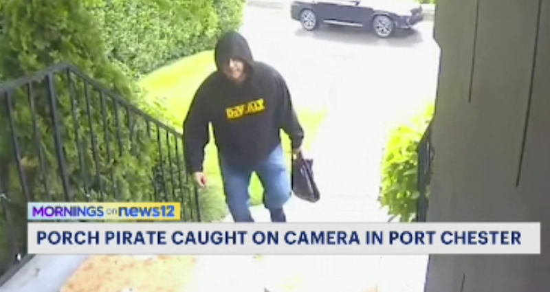 Story image: Man in black hoodie takes three packages from Port Chester home