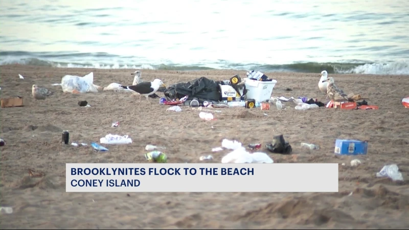 Story image: Coney Island beach left covered in trash overnight amid hot weather