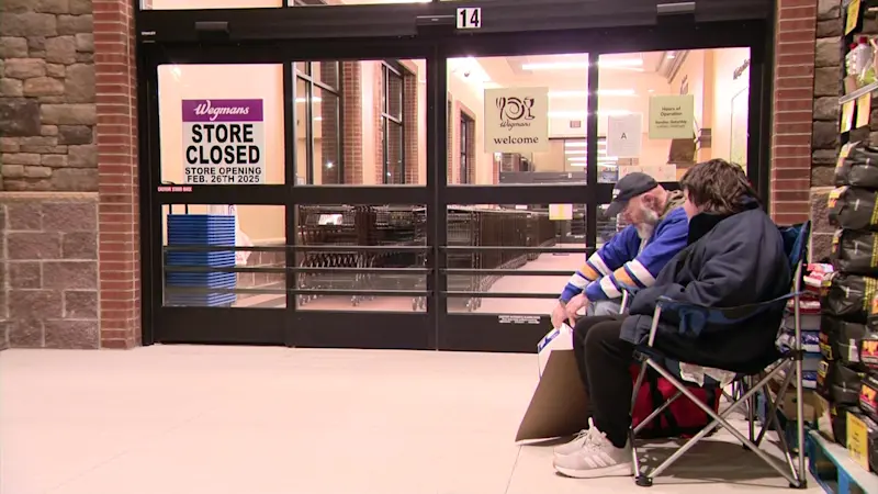 Story image: Fans line up ahead of of LI's first Wegmans supermarket opening 