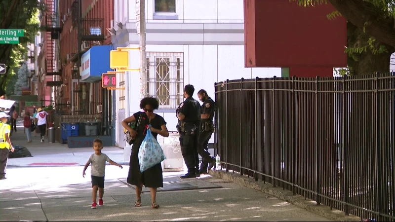 Story image: NYPD seen outside PS 316 following double shooting in Prospect Heights on Wednesday 