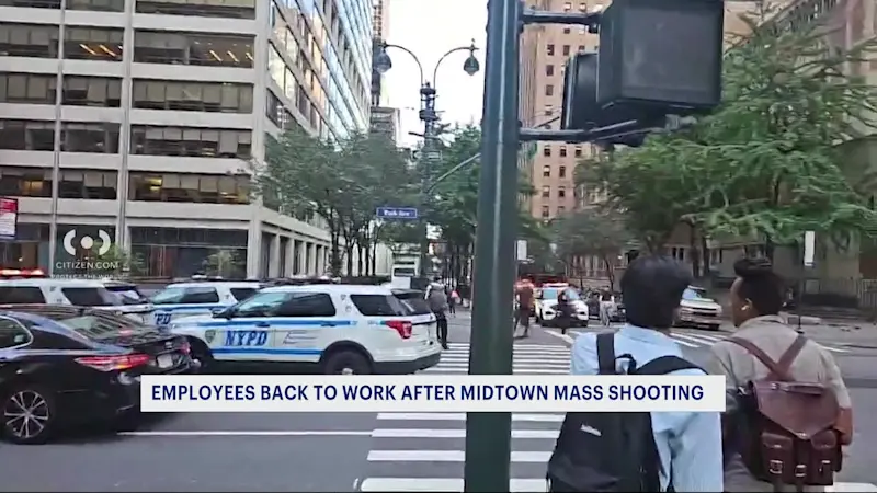 Story image: Workers return to Manhattan building where gunman killed 4  