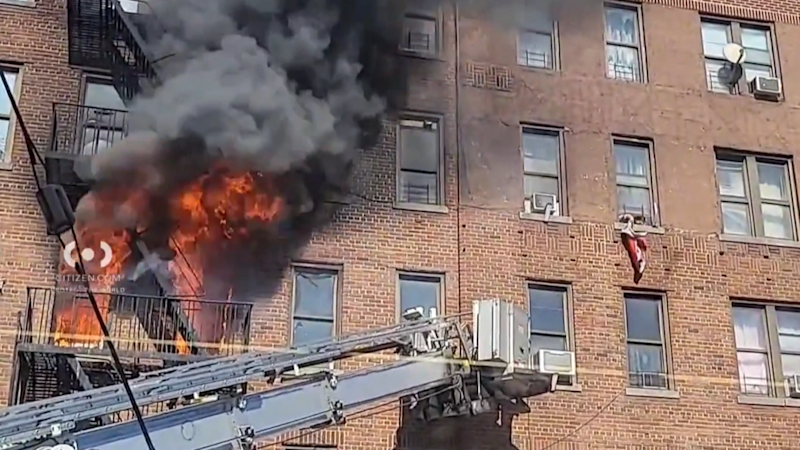 Story image: Person seen waving out window as inferno tears through Kingsbridge apartment building, hospitalizing 12