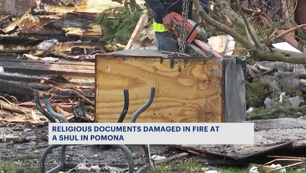 Religious leaders work to salvage sacred Torah scrolls after fire