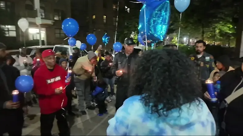 Story image: Candlelight vigil remembers victim found in trash outside Flatbush building