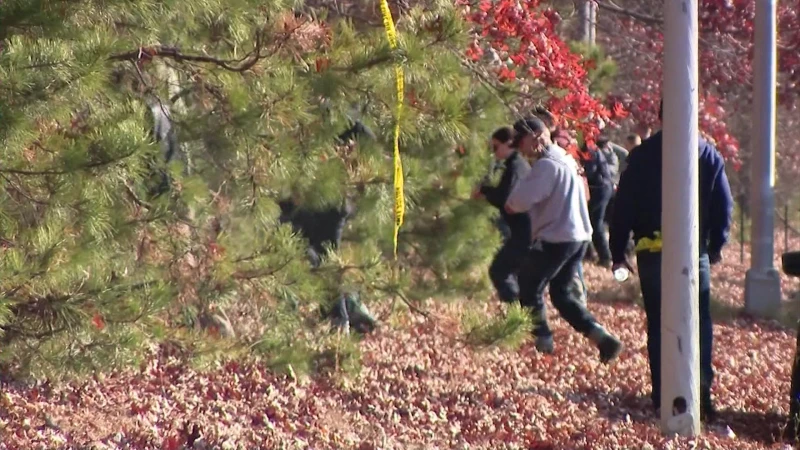 Story image: Police searching woods in Shoreham for Rocky Point man accused of killing father