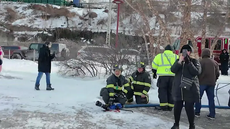 Story image: Icy Hudson off limits: Polar plungers get sprayed with firehose for Ossining charity