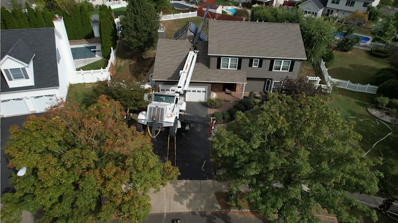 Story image: Crane installing backyard hot tub falls on top of Hamilton Township home