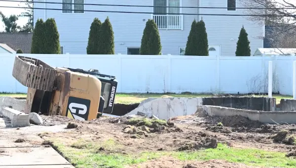 Excavator flips into foundation of home in Bellmore