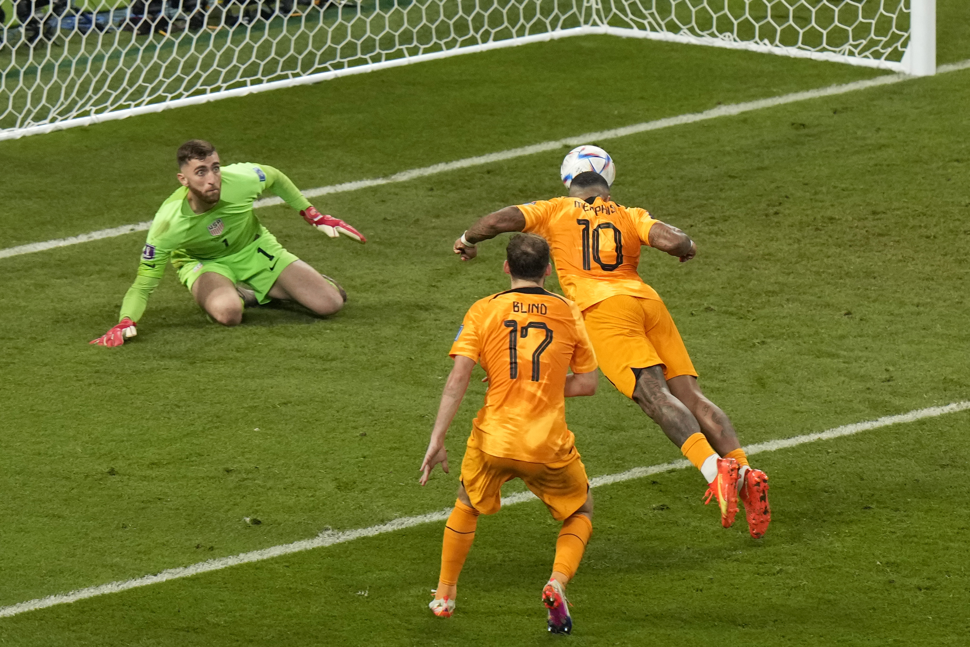 Memphis Depay of the Netherlands, right, tries to score past goalkeeper Matt Turner of the United States during the World Cup round of 16 soccer match between the Netherlands and the United States, at the Khalifa International Stadium in Doha, Qatar, Saturday, Dec. 3, 2022. (AP Photo/Luca Bruno)