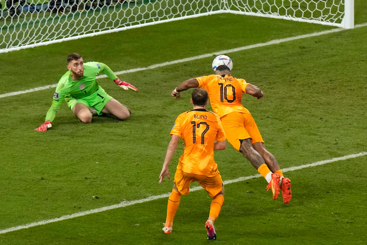 Memphis Depay of the Netherlands, right, tries to score past goalkeeper Matt Turner of the United States during the World Cup round of 16 soccer match between the Netherlands and the United States, at the Khalifa International Stadium in Doha, Qatar, Saturday, Dec. 3, 2022. (AP Photo/Luca Bruno)