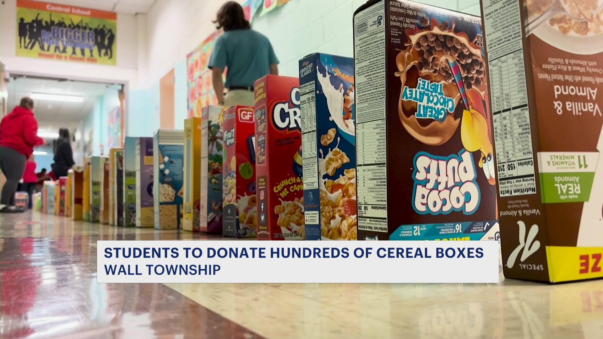 Students collect 1,000 cereal boxes for charity, knock them down like dominoes