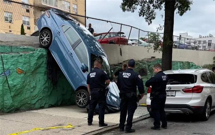 Story image: Bystanders rescue man from car that crashed over concrete wall in Allerton