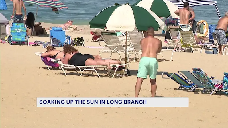 Story image: Beachgoers enjoy the weather in Long Branch ahead of the weekend