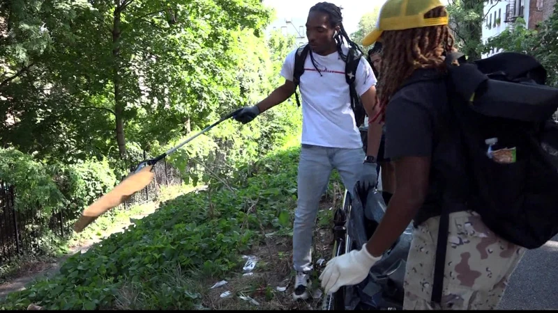 Story image: Volunteers come together to clean up local green space, call on NYC officials for more cleaning efforts