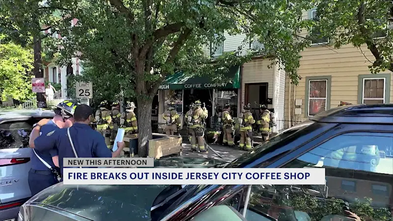 Story image: Jersey City firefighters respond to a fire at a coffee shop on Grand Street