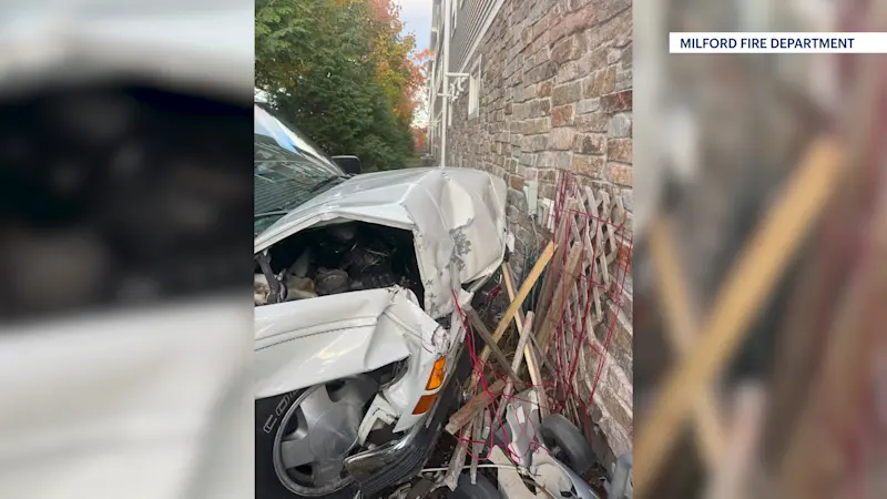 Story image: Person hospitalized after car strikes Milford building