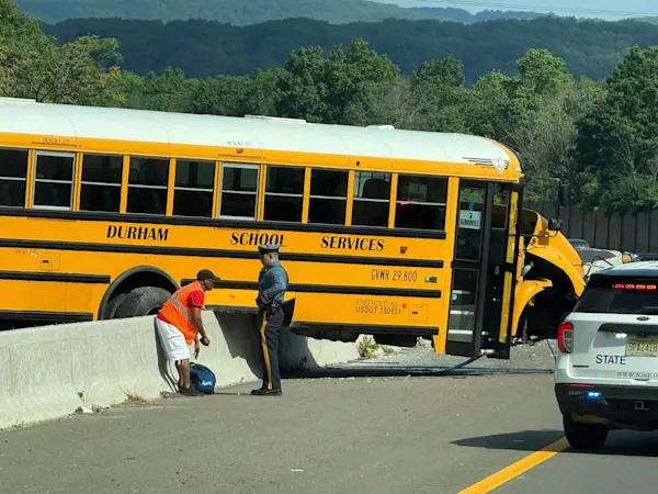 Story image: Police: No injuries reported when truck strikes school bus on I-80