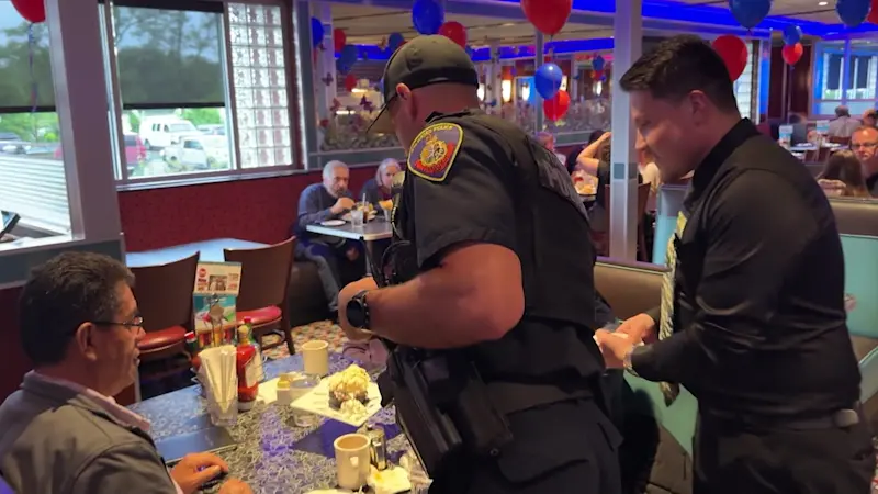 Story image: 'Little different role for us.' Police wait tables at Tip-A-Cop event to benefit Stamford PAL