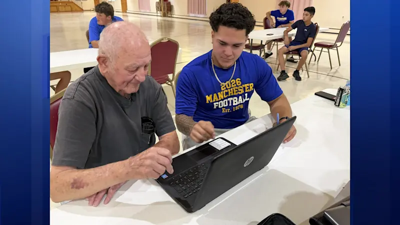 Story image: Jersey Proud: Manchester HS football players help seniors build tech skills