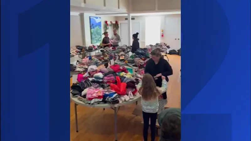 Story image: Volunteers pack children's clothing for LA wildfire victims