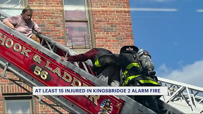 Story image: Person seen waving out window as inferno tears through Kingsbridge apartment building, hospitalizing 15