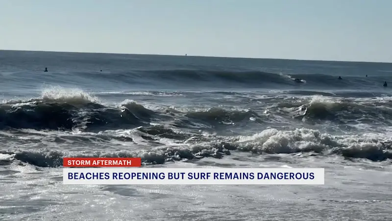 Story image: Beachgoers stay on shore in Manasquan as Erin heads out to sea