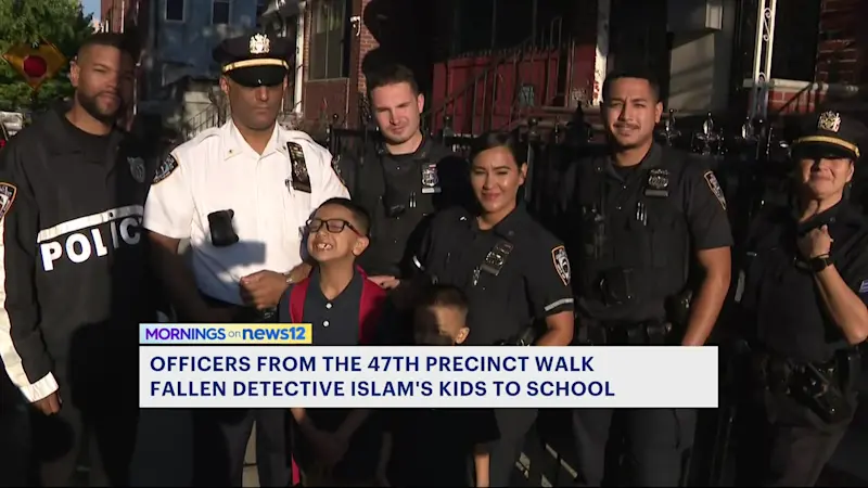 Story image: Police walk children of late Det. Didarul Islam to school on first day