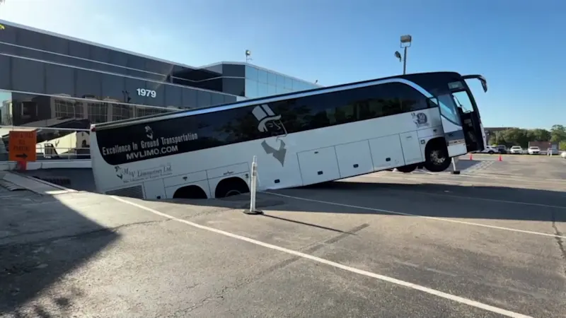 Story image: Coach bus partially falls into underground garage after collapse in North New Hyde Park