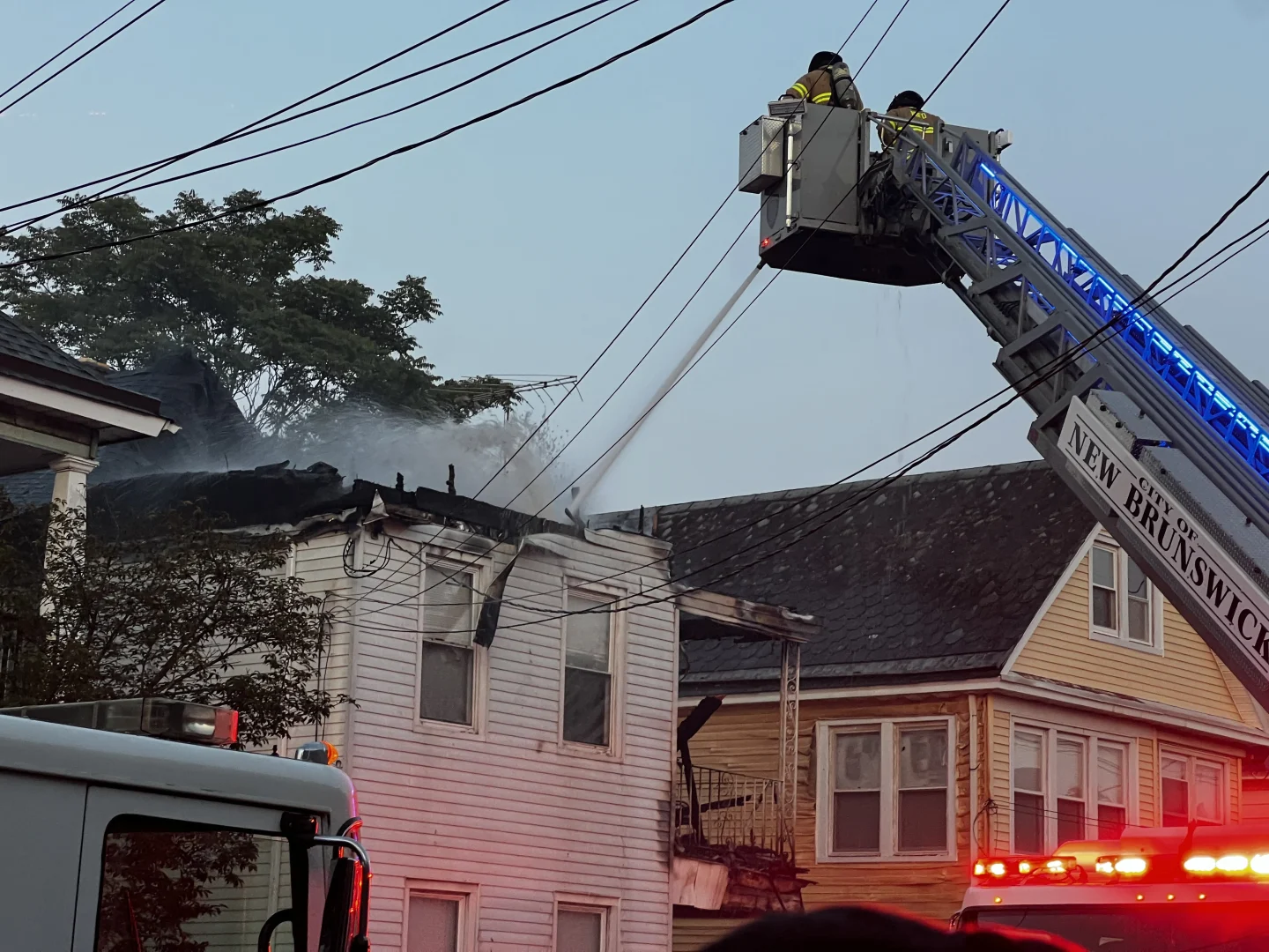 Crews battle large house fire in New Brunswick