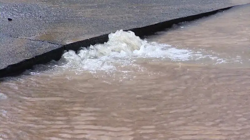 Story image: Hole in Baldwin road after water main break sends water gushing into the streets