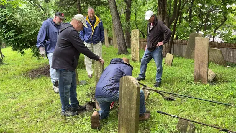 Story image: Volunteers restore Revolution-era gravestone at Mills Pond Cemetery