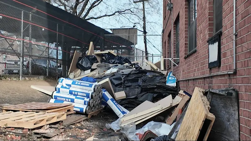 Story image: Rotting debris piles up outside Wakefield apartment building 