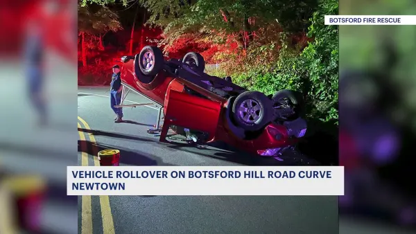 Car rolls over at curb on Newtown road