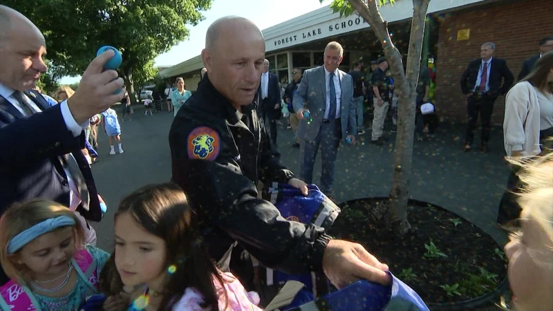 Story image: Nassau police commissioner greets families on 1st day of school to let them know police are 'on their team'