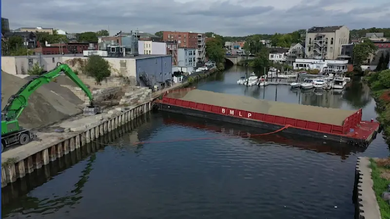 Story image: ‘It’s crazy.’ 140-foot barge stuck across Norwalk River since Saturday; plan set to free it Wednesday