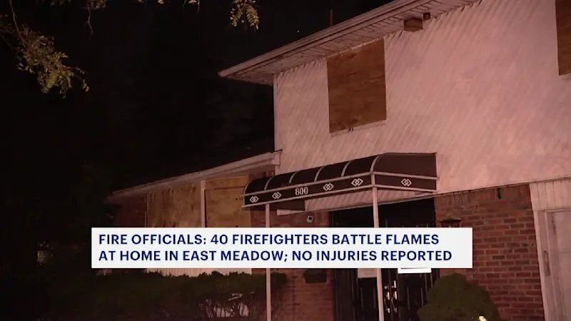 Story image: Firefighters battle flames at East Meadow home