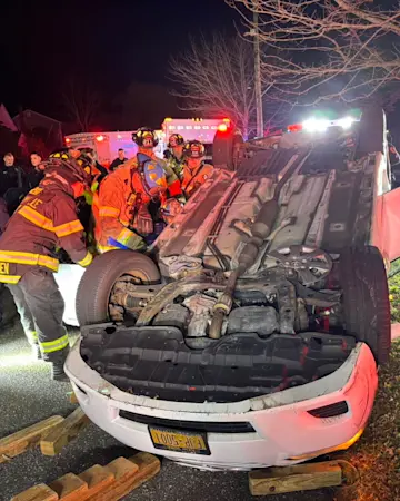 Story image: Driver trapped after hitting parked car, overturning in Sayville