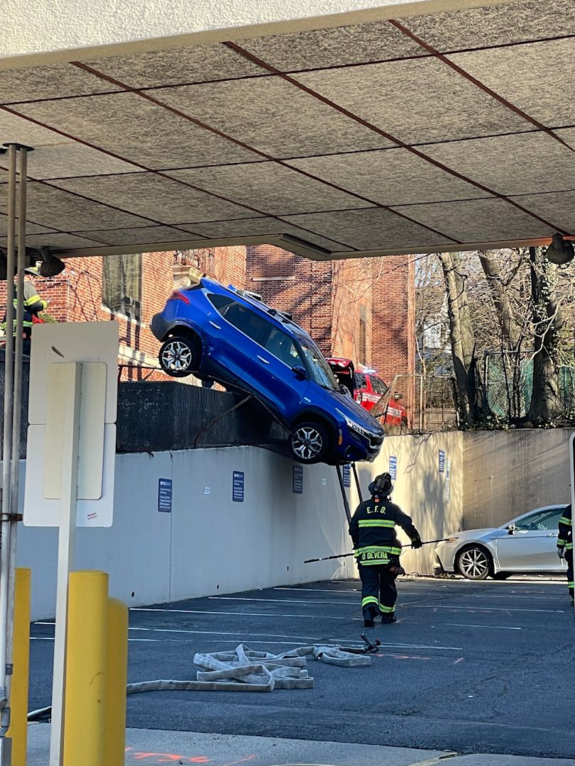 Incredible pictures Accident in Englewood leaves car dangling off ledge