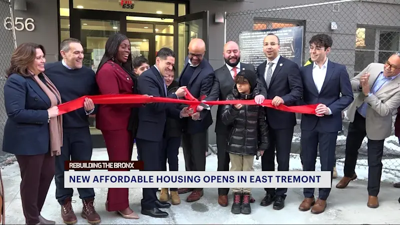 Story image: Local officials celebrate the grand opening of Belmont Cove, a new affordable housing development in East Tremont