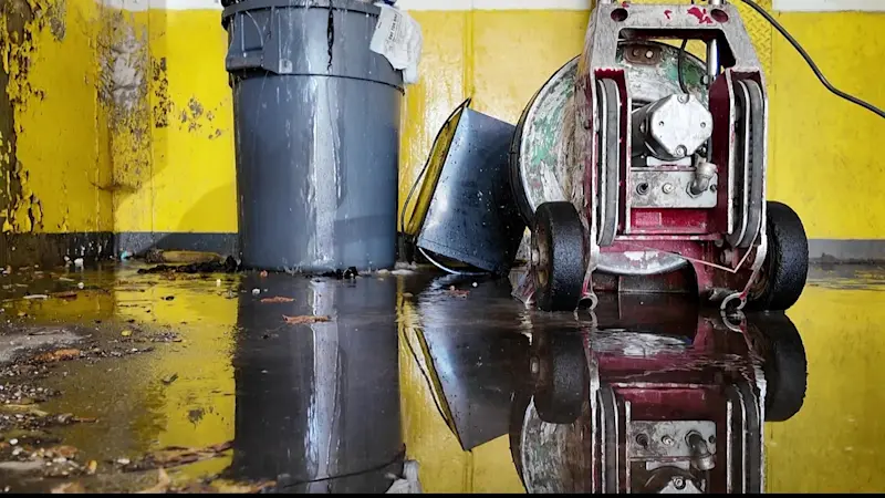 Story image: East New York residents wade through sewage water in parking garage