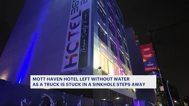 Story image: Mott Haven hotel without water as truck is left in sinkhole steps nearby