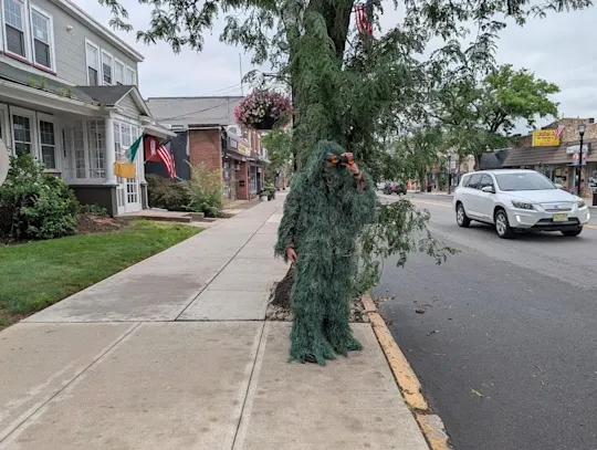 Police officer dresses as a shrub