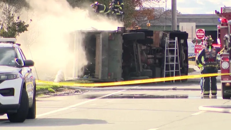 Story image: Police: One dead after garbage truck overturns and catches fire in East Islip