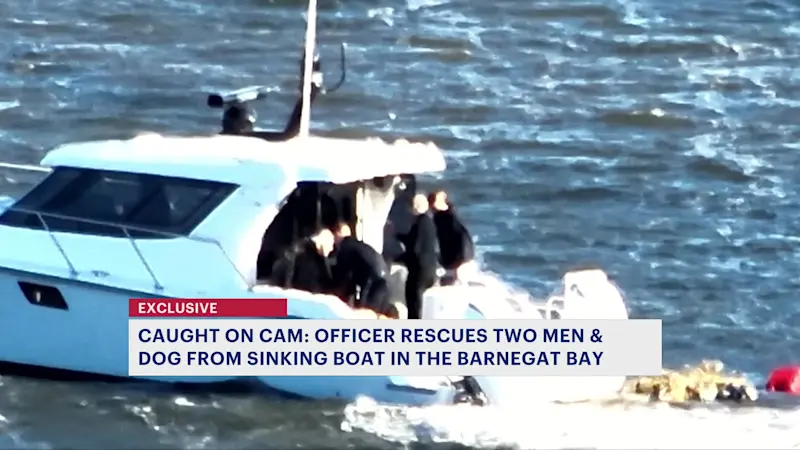 Story image: Police officers rescue 2 men, dog from sinking boat in Barnegat Bay