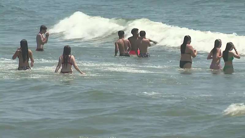 Story image: Crowds pack Jersey Shore beaches to beat the heat ahead of severe weather
