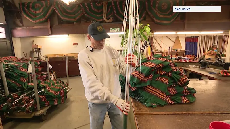 Story image: Jones Beach lifeguard works to repair umbrellas for summer season 