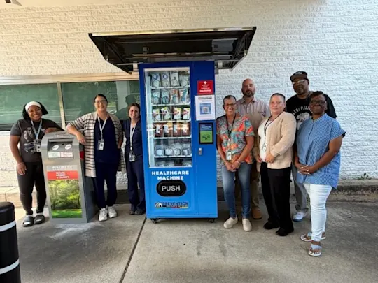 Suburban-Health-Clinic-team-with-machine-768x1024