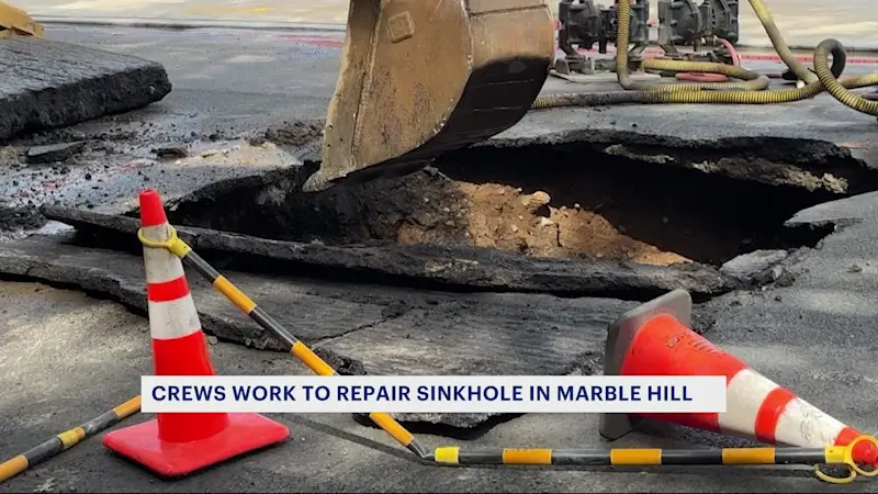 Story image: 'It was like a swimming pool.' Sinkhole shuts down road in Marble Hill 