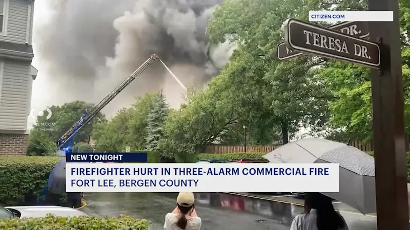 Story image: Officials: Firefighter injured battling large fire at Fort Lee auto shop