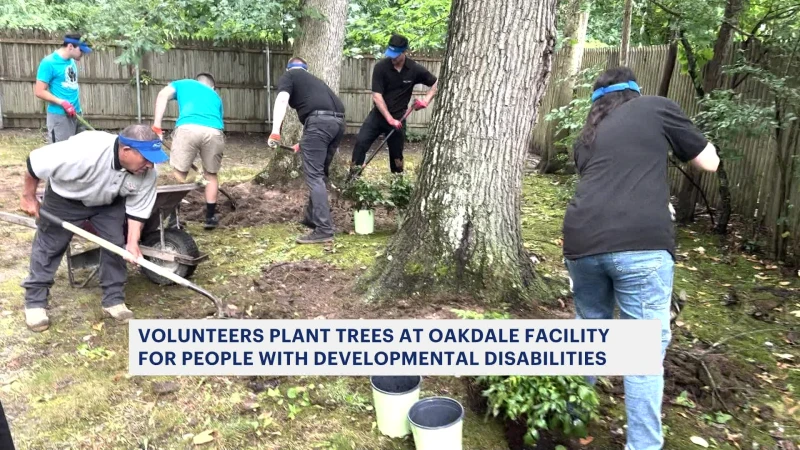 Story image: Volunteers plant trees at Oakdale facility for people with developmental disabilities